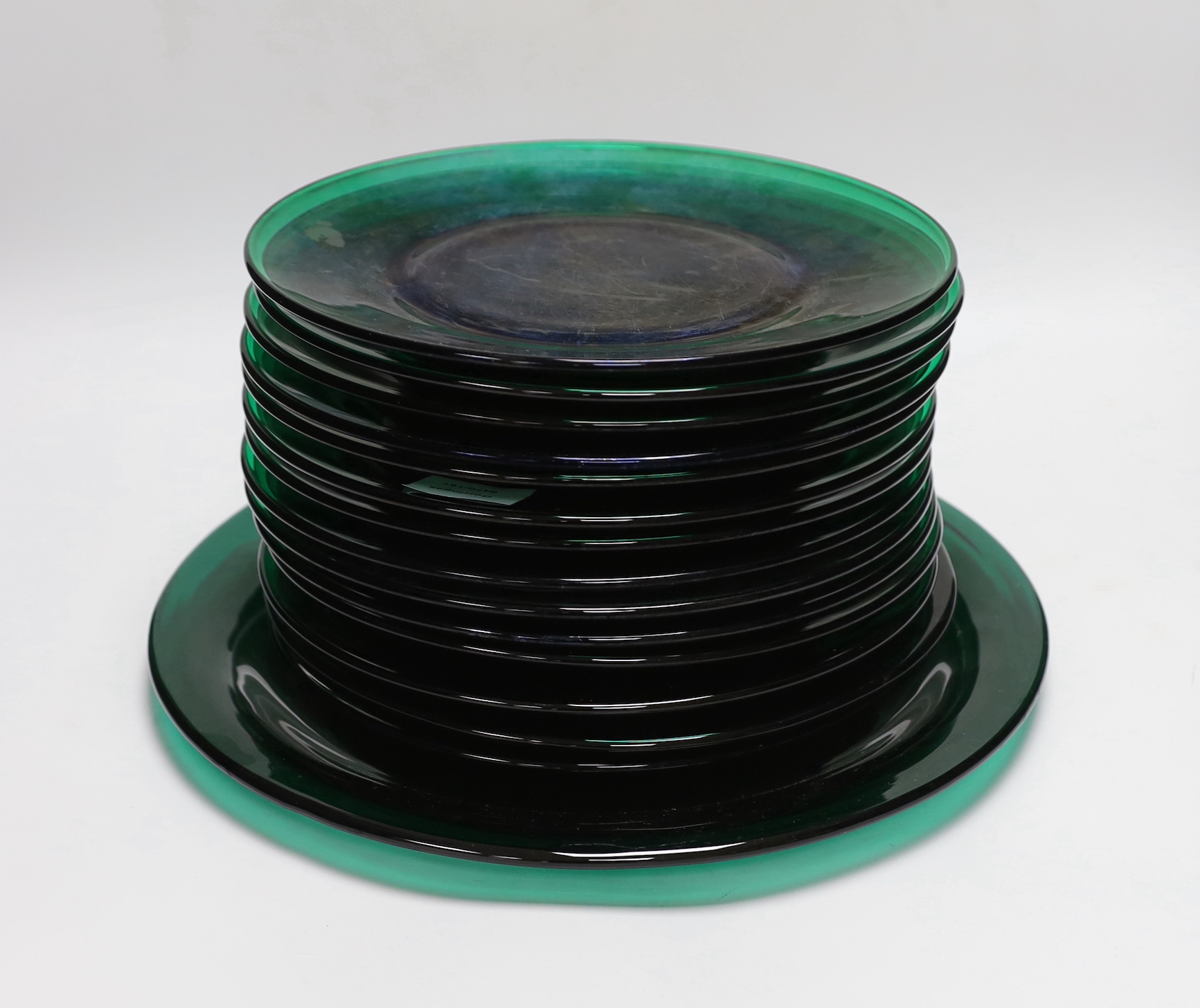 Fifteen Roland James of San Francisco green glass plates and one large serving plate